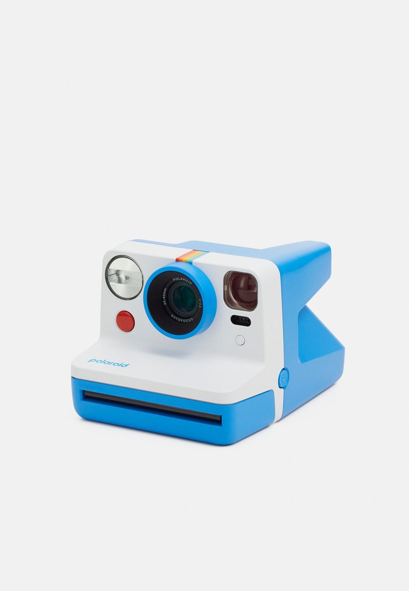 Polaroid instant camera with a blue and white design, circular lens housing, flash, red button, and film slot at the front.