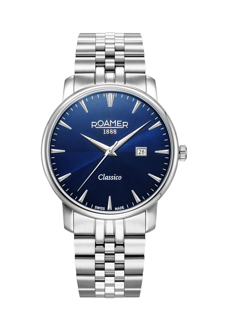 Reloj de acero inoxidable con esfera redonda azul, marcadores de hora plateados, ventanilla de fecha a las 3, y pulsera de metal. Nombre de la marca "Roamer 1888" mostrado.