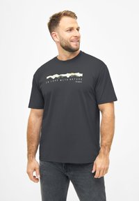 Donkergrijze t-shirt met korte mouwen, voorzien van een grafisch ontwerp in lichte kleuren met de tekst "VERLIEFD OP DE NATUUR" aan de voorkant.