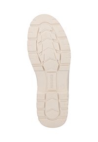 Suola della scarpa di colore crema con un motivo di grip testurizzato, caratterizzato da scanalature profonde e sezioni rialzate per una migliore aderenza. Etichetta stampata sul lato.