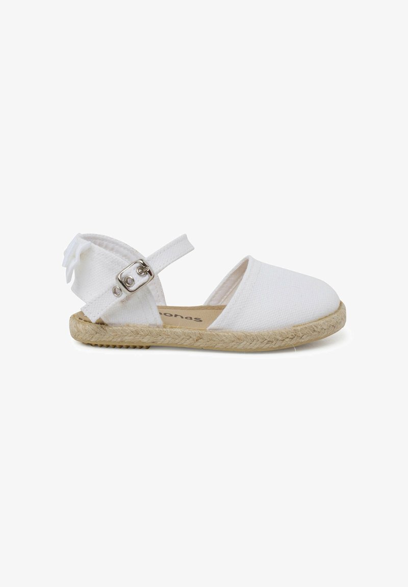 Valkoinen espadrille-kengä, jossa on kangasosa, suljettu kärki, kantapehmuste metallisella yksityiskohdalla ja kudottu juuttipohja. Koristelu nauha kantapäällä.