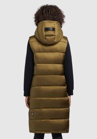 Olive green padded long vest with a hood, featuring horizontal quilted design, smooth texture, and a logo patch near the hem.