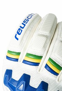 White goalkeeper glove with textured surface, featuring a blue logo, colorful horizontal stripes (green, yellow, blue), and rubberized accents.