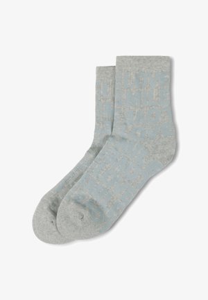 Paire de chaussettes gris clair avec des motifs textes bleus comportant des mots comme "LOVE" et "SMILE" disposés de manière aléatoire.