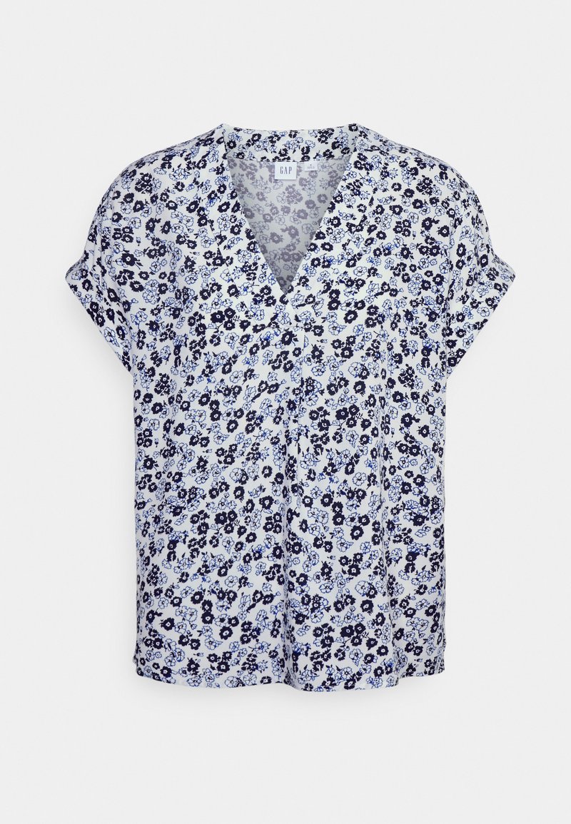 Blusa de mangas curtas em tecido leve, apresentando um padrão floral azul sobre um fundo branco, com decote em V e um corte descontraído.