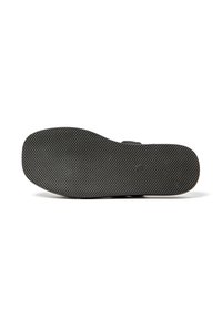 Black rubber shoe sole with textured pattern, smooth edges, and rounded toe; features a subtle logo imprint at the center.