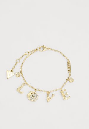 Gold chain bracelet featuring charm letters spelling "LOVE," floral accents, triangular tag, and decorative links. Clasp closure at end.