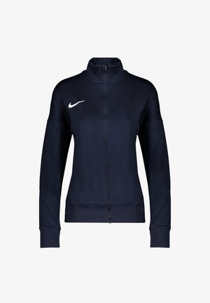 Marineblaue Sportjacke mit durchgehendem Reißverschluss, hohem Kragen und weißem Nike-Swoosh auf der linken Brust, langen Ärmeln und anliegenden Bündchen.