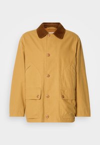 Giacca di cotone gialla con colletto in corduroy marrone, ampie tasche laterali e chiusura con bottoni sul davanti.