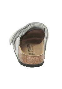 Gray felt clogs with a cork footbed, back view. Features layered straps and a textured outsole, indicating comfort and support.