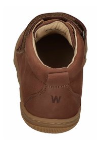 Brown leather ankle boot with a soft interior, velcro closure, and a textured rubber sole. Features a logo embossed on the heel.