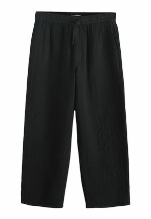 Black textured wide-leg pants with elastic waistband and drawstring, featuring side pockets.