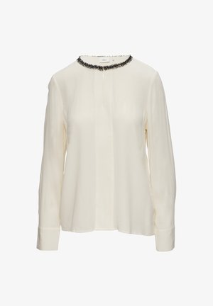 Cream long-sleeve blouse made of smooth fabric, featuring a black beaded trim around the round neckline and a straight hem.