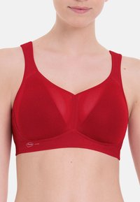 Roter Netz-Sport-BH mit einem strukturierten, volldeckenden Design. Verfügt über breite Träger und ein glattes Band für Komfort und Unterstützung.