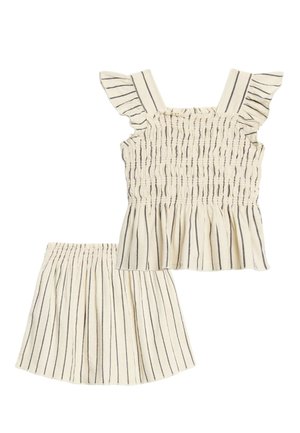 Kinderoutfit in Creme mit schwarzen vertikalen Streifen, bestehend aus einem ärmellosen Top mit Rüschen und einem Rock mit elastischem Bund.