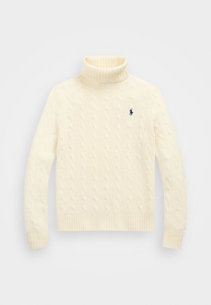 Cream cable-knit turtleneck sweater with ribbed cuffs and hem. Features small navy logo on the chest. Soft, textured fabric. Long sleeves.
