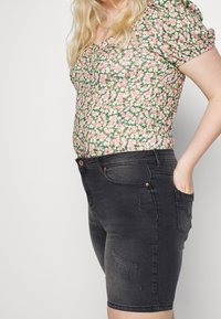 Black denim shorts with a distressed texture, featuring five-pocket design, belt loops, and copper-tone hardware.