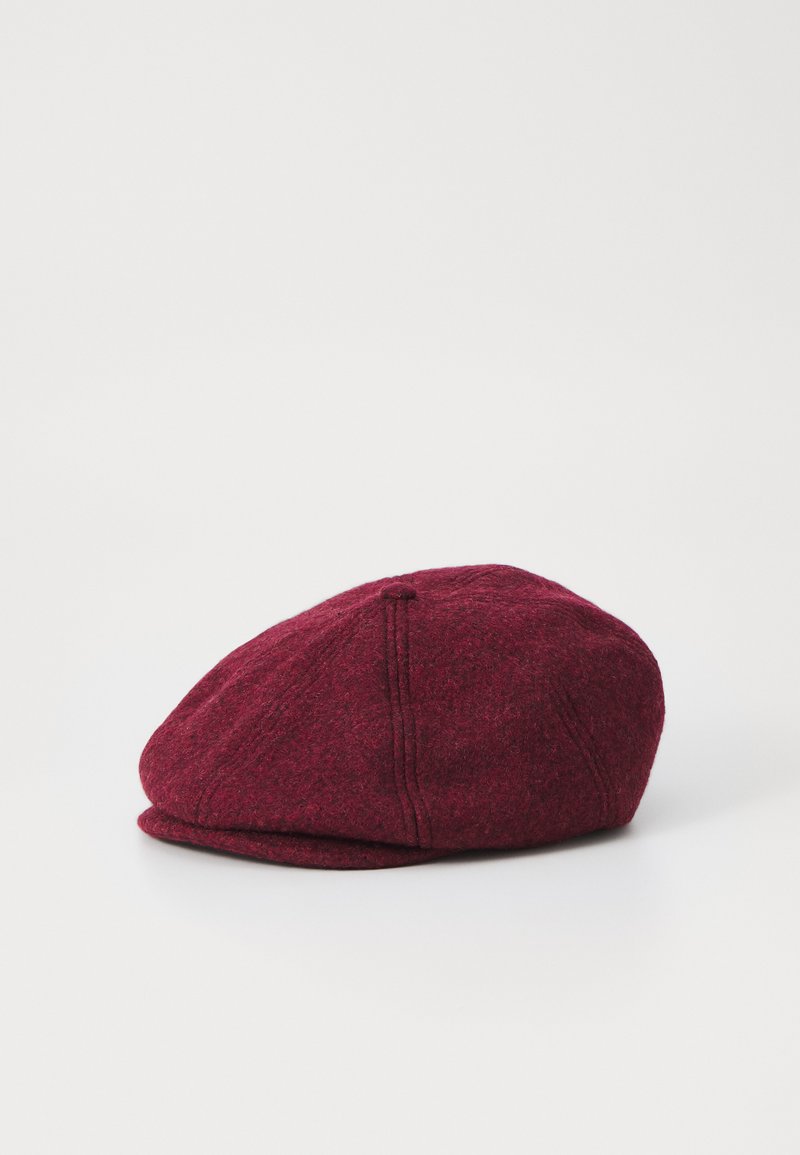 Burgundy wool cap with a rounded shape, soft texture, and visible stitching details. Features a small brim and layered design elements.