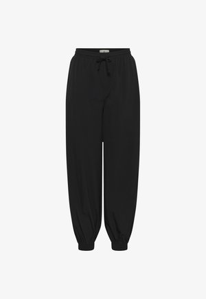 Pantalon de jogging noir à coupe ample avec taille élastique et cordon de serrage, doté de poignets élastiques aux chevilles.