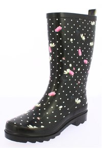 Botte de pluie en caoutchouc noire avec des pois blancs et des motifs floraux en rose et blanc. Elle est dotée d'une semelle texturée pour une meilleure adhérence et d'une languette de traction.
