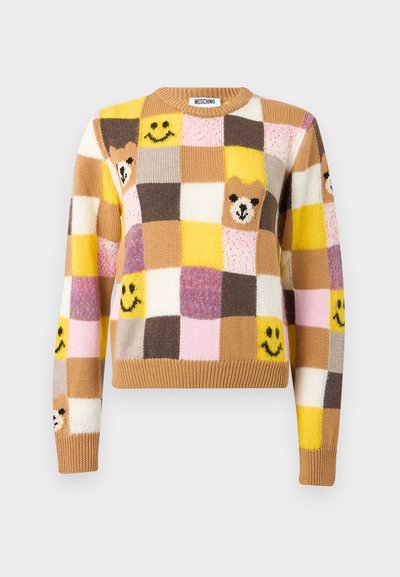 Pull en patchwork avec des carrés jaunes, bruns, roses et crème, arborant des visages souriants et des visages d'ours sur le devant et les manches.