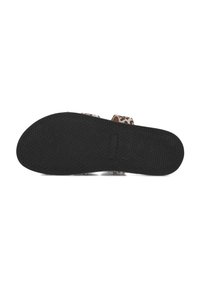 Black rubber sole of a sandal with a textured surface, featuring two animal print fabric straps and a beige padded footbed.
