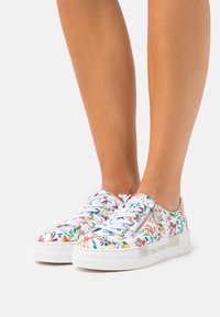 Sneaker bianche con motivo floreale, dotate di linguetta imbottita, chiusura con lacci e zip laterale; suola in gomma testurizzata per presa e comfort.