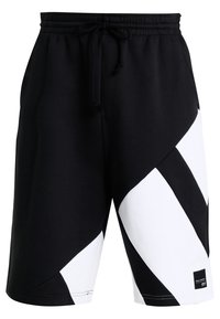 Black and white shorts featuring a geometric design, made of soft fabric, with an elastic waistband and drawstring, suitable for casual wear.