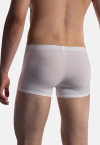White cotton boxer briefs with a soft waistband, featuring a fitted design and smooth texture, highlighting a plain appearance.
