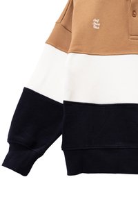 Kleurgeblokte sweatshirt met bruine, witte en marineblauwe secties. Gemaakt van zachte stof met een ribbelstructuur en een knoopsluiting bij de kraag.
