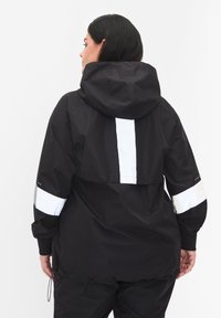 Black waterproof jacket with a hood, featuring white reflective stripes on sleeves and back, and adjustable drawstring at the hem.