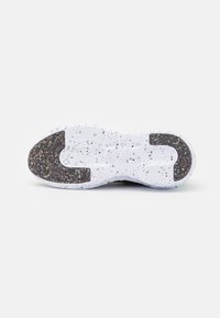 Shoe sole with a textured, white base featuring colorful speckles. Black rubber section for grip at the heel and toe areas.