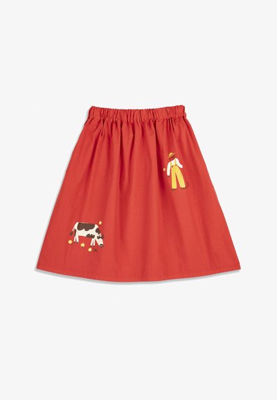 Jupe rouge avec une taille élastique, comportant une petite illustration d'un fermier en salopette jaune et une vache noir et blanc avec des fleurs jaunes.
