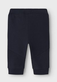 Marineblauwe joggers van een textuurstof, met een geribbelde tailleband en boorden, en hoekige designelementen op de benen.