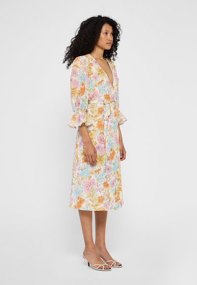 Floral midi dress with a v-neck, puff sleeves, and a tie waist. Features pastel-colored flowers on a yellow background. Textured fabric.