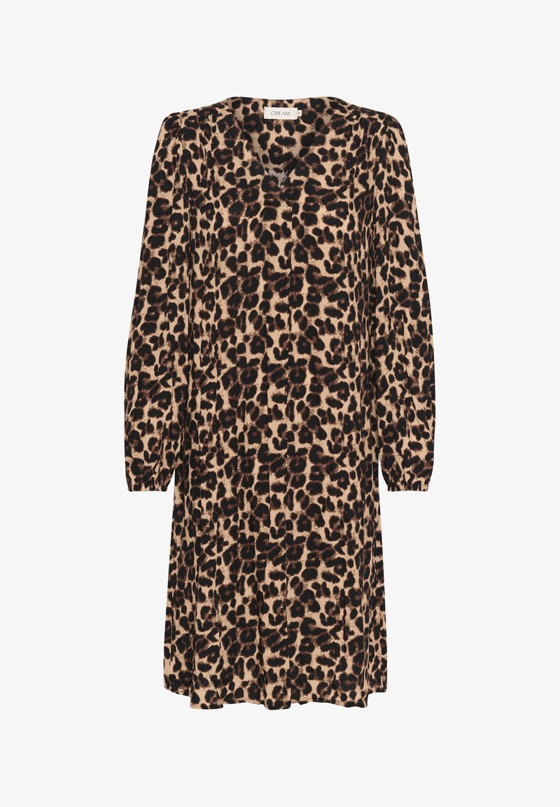 Leopard print dress in beige with black spots, long sleeves, a v-neckline, and loose fit. Fabric has a soft texture and flowy design.