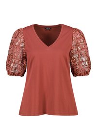 T-shirt en V de couleur rouille avec des manches courtes et bouffantes, ornée de broderies complexes et de paillettes dans des tons de rose et de cuivre.