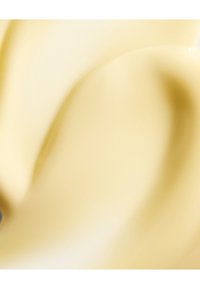 Latte di colore beige chiaro e cremoso con una consistenza liscia e lucida, caratterizzato da morbidi motivi a spirale. Non sono visibili hardware o dettagli notevoli.