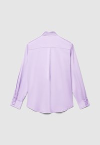 Long-sleeve lavender shirt shown from the back with a center pleat, buttoned cuffs, and a yoke across the shoulders on a gray background.