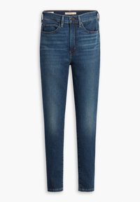 Jeans skinny en denim bleu foncé. Comprend cinq poches, une fermeture par bouton et fermeture éclair, et un délavage minimal. Texture lisse, jambes droites.