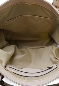 Beige draagtas interieur, met een zachte stoffen voering, een ritszak en een open zak voor organisatie. Gelaagde randen.