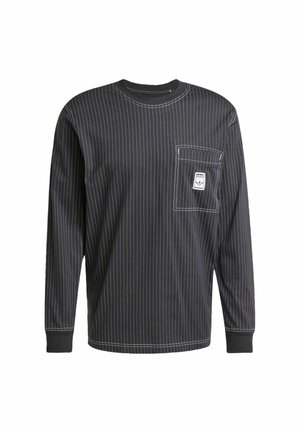 Black long-sleeve shirt with white vertical stripes, round neckline, front pocket, and label accent on pocket. Heavyweight cotton fabric.