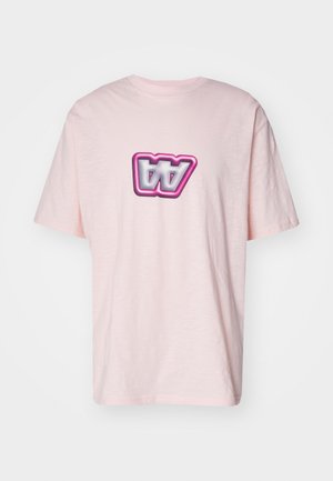 Pink cotton T-shirt featuring a distorted graphic logo in black and white with a pink outline on the front. Short sleeves and relaxed fit.