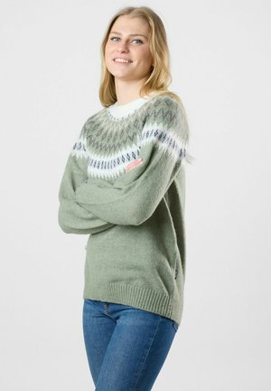 Light green knitted sweater with a patterned yoke in white and grey tones. Ribbed cuffs and hem, loose fit, made from soft material.
