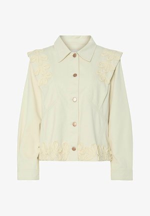 Krémová bunda s knoflíkovým zapínáním, zdobená květinovou výšivkou na ramenou a lemu. Vyrobena z jemné tkaniny s prodlouženými rukávy.