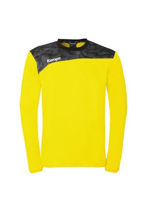 Gelbes langärmeliges Sporttrikot mit einem schwarzen geometrischen Muster über den Schultern und dem weißen "Kempa"-Logo auf der oberen Brust.