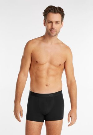 Zwarte boxershorts van rekbaar materiaal, met een gladde textuur en een elastische tailleband met een subtiele logo.