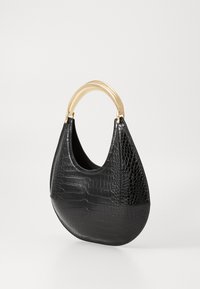 Black croc-embossed leather handbag with curved shape and gold-tone rigid handle against plain background.