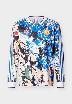 Long-sleeve soccer jersey with blue, black, white, and beige abstract splatter design, red Adidas logo, and Manchester United crest on front.