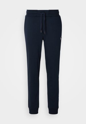 Pantaloni felpati blu navy realizzati in tessuto morbido, con vita elastica e cordino, e polsini aderenti alle caviglie.